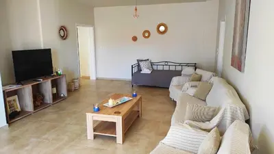 a living room with two couches and a coffee table at Comfortable Apartment Close to the Airport in Spáta