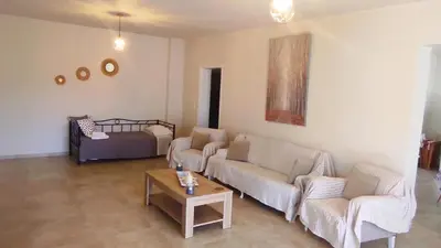 a living room with two couches and a coffee table at Comfortable Apartment Close to the Airport in Spáta