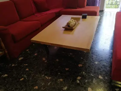 a living room with a red couch and a coffee table at Galini in Athens