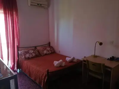 a small bedroom with a bed and a desk with a lamp at Galini in Athens