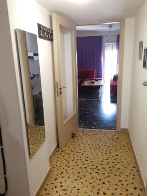 a hallway with an open door and a hallway with a room at Galini in Athens