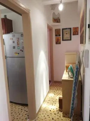 a kitchen with a refrigerator and a table with a box at Galini in Athens