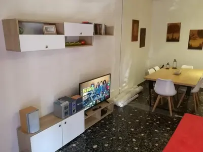 a living room with a tv and a dining room table at Galini in Athens