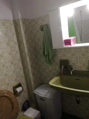 a bathroom with a green sink and a toilet at Galini in Athens