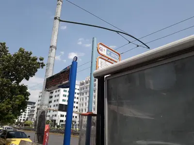 a bus stop with a sign in front of a building at Socrates path in Athens