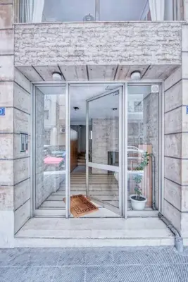 an open glass door in a building with a plant at MUSE A Dreamy and Fresh New apartment in Athens
