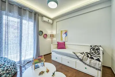 a small bedroom with a bed and a window at MUSE A Dreamy and Fresh New apartment in Athens