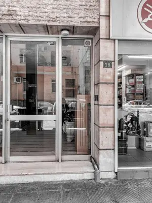 a store front with glass doors on a building at MUSE A Dreamy and Fresh New apartment in Athens