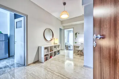 an open door to a living room with a mirror at MUSE A Dreamy and Fresh New apartment in Athens