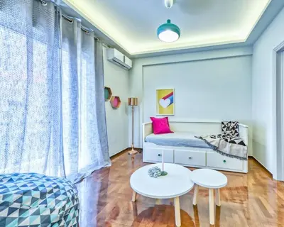 a bedroom with a bed and two tables in a room at MUSE A Dreamy and Fresh New apartment in Athens