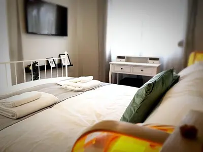 a bedroom with a bed with towels on it at Victoria 5star / 5BR BigApt / Sauna / 2min to metro in Athens