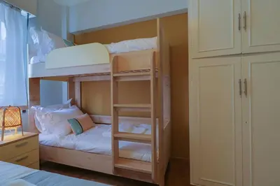 a bedroom with two bunk beds with a ladder at Victoria 5star / 5BR BigApt / Sauna / 2min to metro in Athens