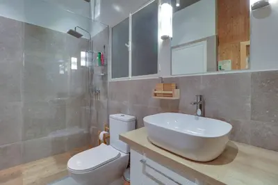 a bathroom with a white sink and a toilet at Victoria 5star / 5BR BigApt / Sauna / 2min to metro in Athens