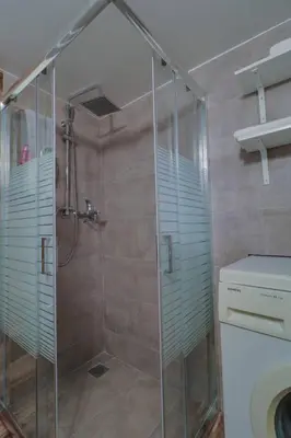 a shower with a glass door in a bathroom at Victoria 5star / 5BR BigApt / Sauna / 2min to metro in Athens