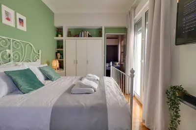 a bedroom with a bed with towels on it at Victoria 5star / 5BR BigApt / Sauna / 2min to metro in Athens