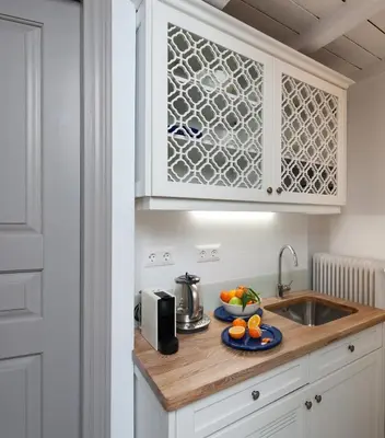a kitchen with a sink and a plate of fruit on a counter at Acropolis TownHouseCo Suites in Athens