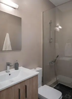 a bathroom with a sink and a toilet and a shower at Absolute Athens ΙΧ in Athens