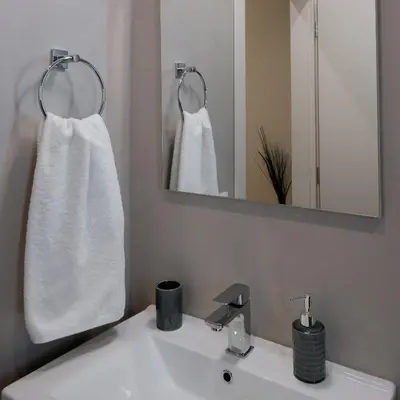 a bathroom with a white sink and a mirror at Absolute Athens ΙΧ in Athens