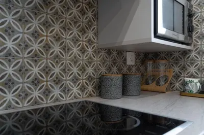 a kitchen with a wall with a patterned wall at Absolute Athens ΙΧ in Athens