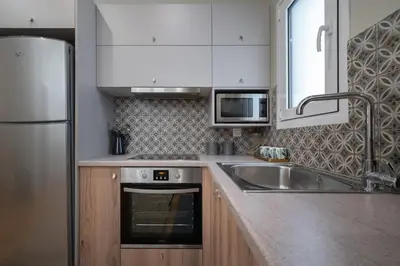 a kitchen with a sink and a stainless steel refrigerator at Absolute Athens ΙΧ in Athens