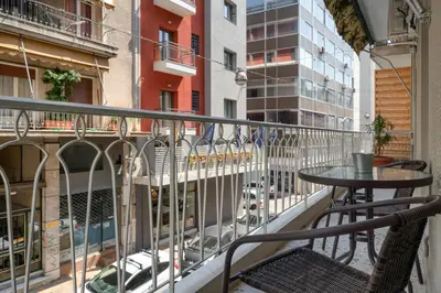 a balcony with a table and a view of a street at Absolute Athens ΙΧ in Athens