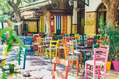 a group of colorful chairs and tables in a restaurant at Absolute Athens ΙΧ in Athens