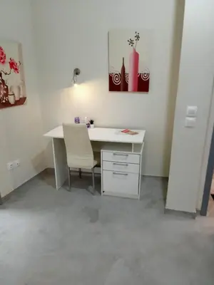 an office with a white desk and a chair at Koukaki-comfy with a balcony apt. in Athens