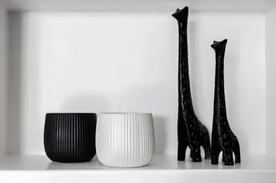 three giraffes are sitting on a shelf at Amazing Seafront Apartment Athens Riviera in Athens