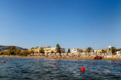 a body of water with some red balls in the water at Amazing Seafront Apartment Athens Riviera in Athens