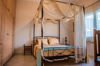 a bedroom with a bed with a canopy at ANAFIS COMFORT in Athens