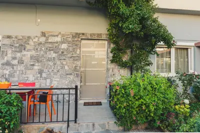 a patio with a table and chairs in front of a building at ANAFIS COMFORT in Athens