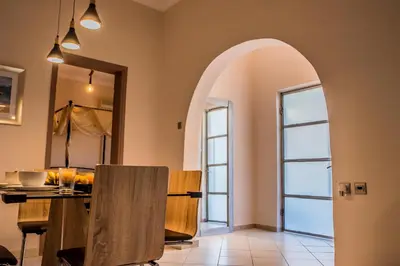 a dining room with an archway and a table at ANAFIS COMFORT in Athens