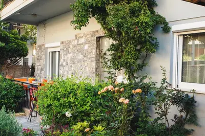 a house with flowers on the side of it at ANAFIS COMFORT in Athens