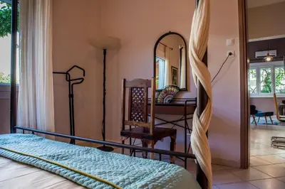 a bedroom with a bed and a desk and a mirror at ANAFIS COMFORT in Athens