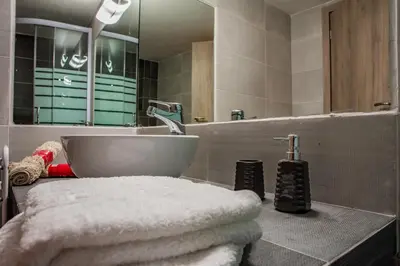 a bathroom with a sink and a large mirror at ANAFIS COMFORT in Athens
