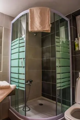 a shower with a glass door in a bathroom at ANAFIS COMFORT in Athens