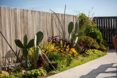 a garden with flowers and plants next to a fence at Impressive Apartment with Amazing Views - MK1 in Athens