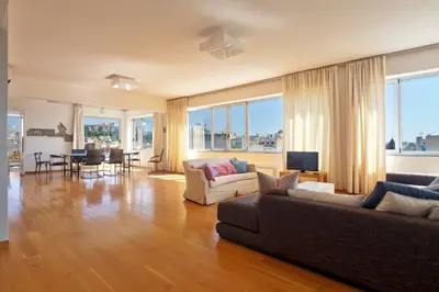 a living room with two couches and a dining room at Impressive Apartment with Amazing Views - MK1 in Athens