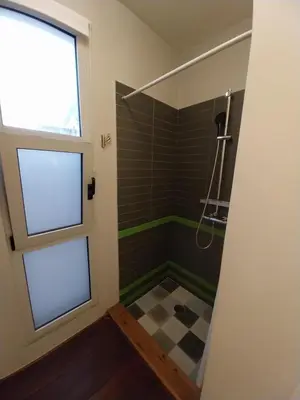 a bathroom with a shower with a window and a checkered floor at Impressive Apartment with Amazing Views - MK1 in Athens