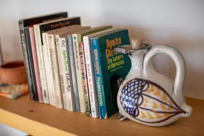 a book shelf with books and a vase on it at Impressive Apartment with Amazing Views - MK1 in Athens