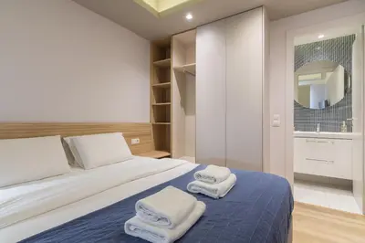 a bedroom with a bed with towels on it at Kolokotroni Lofts Syntagma in Athens