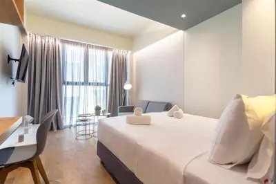 a hotel room with a large bed and a desk at Kolokotroni Lofts Syntagma in Athens