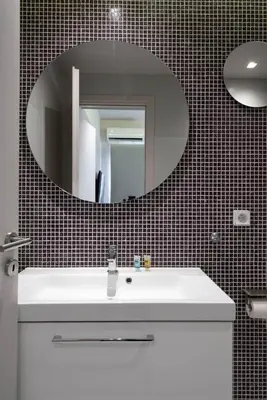 a bathroom with a white sink and a mirror at Kolokotroni Lofts Syntagma in Athens