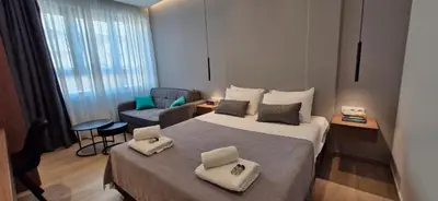 a small hotel room with a bed and a couch at Kolokotroni Lofts Syntagma in Athens