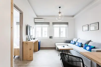 a living room with a couch and a table at CosmosDome / Best apartment in the heart of Athens ! in Athens