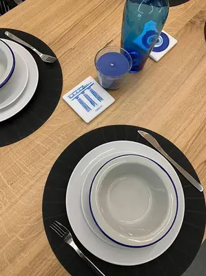 a table with plates and utensils on a wooden table at CosmosDome / Best apartment in the heart of Athens ! in Athens