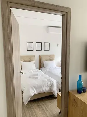 a bedroom with two beds and a mirror at CosmosDome / Best apartment in the heart of Athens ! in Athens