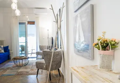 a living room with a chair and a table at Unique apartment in Glyfada center in Athens