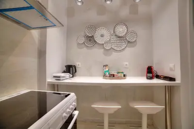 a kitchen with a counter with plates on the wall at Unique apartment in Glyfada center in Athens