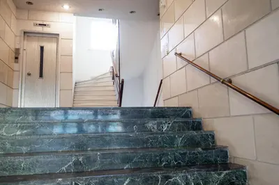 a staircase in a building with green marble steps at Unique apartment in Glyfada center in Athens